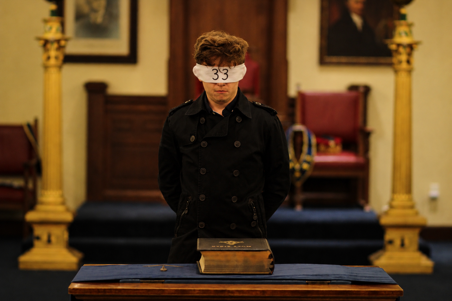 Blindfolded figure with 33 standing in a chapel